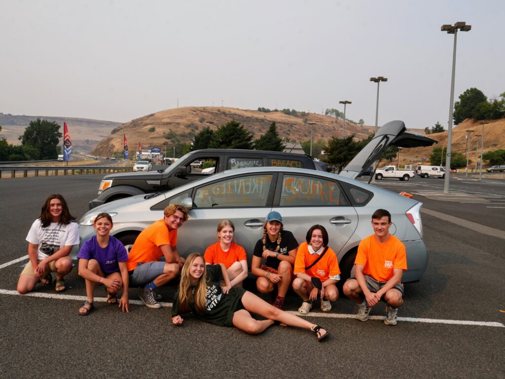 Youth Salmon Protectors write "Free the Snake" on a Prius at the Clearwater Casino in Lewiston, ID
